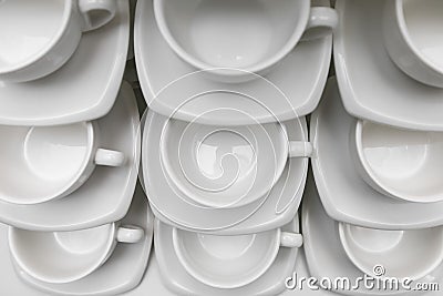 Many rows clean white coffee cup, tea spoon and saucer on table. Empty mug set in row prepare for coffee break Stock Photo