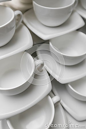Many rows clean white coffee cup, tea spoon and saucer on table. Empty mug set in row prepare for coffee break Stock Photo
