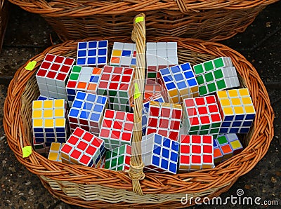 Many Rubik cubes stacked in a wicker basket. Editorial Stock Photo