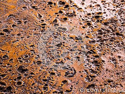 Rugged holes on the rusty color concrete floor Stock Photo
