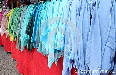 many shirts of many color for sale at market Stock Photo