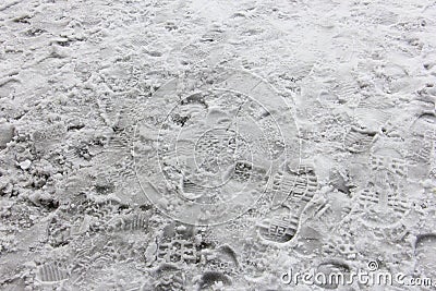 Many shoeprints in the dirty snow Stock Photo