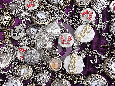 Many silver ladies watches on violet velvet background Stock Photo