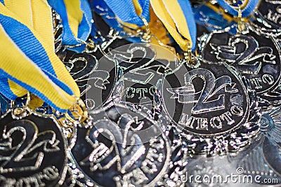 Many silver medals with blue ribbons on a silver tray Stock Photo