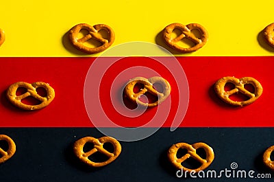 Many small pretzels on a background of the German flag colors Stock Photo