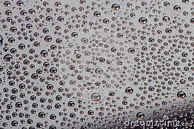 Many small water drops on the surface of cellphone hydrophobic coated glass screen Stock Photo