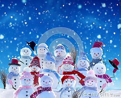 Many snowmen standing in winter Christmas landscape. Stock Photo