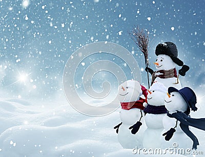 Many snowmen standing in winter Christmas landscape Stock Photo