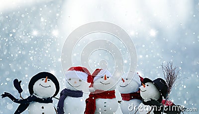 Many snowmen standing in winter Christmas landscape Stock Photo