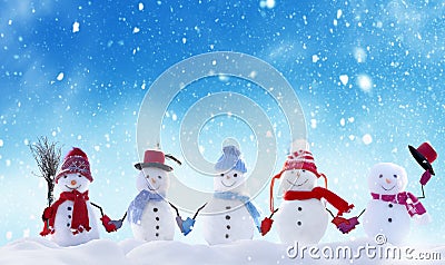 Many snowmen standing in winter Christmas landscape. Stock Photo