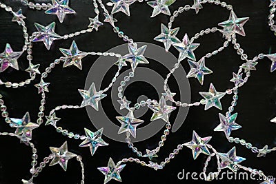 Many sparkling, shimmering star chains for Christmas, on black background Stock Photo