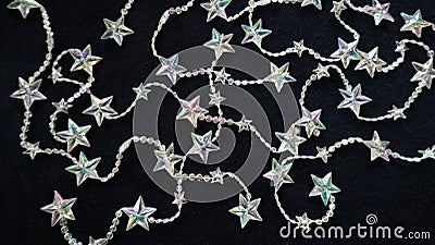 Many sparkling, shimmering star chains for Christmas, on black background Stock Photo