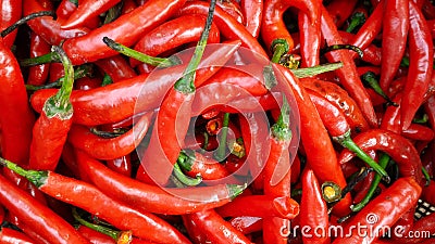 Many spicy red chillies are sold in the market. Top view Stock Photo