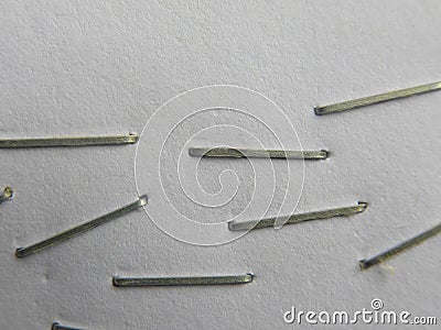 Many staples on white paper Stock Photo