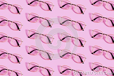 Many reading glasses on pink background pattern Stock Photo