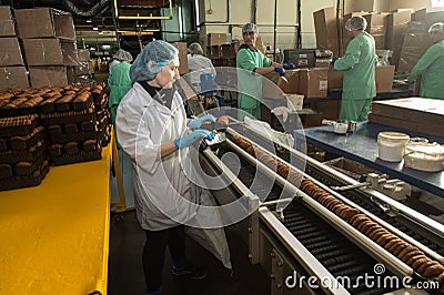 Many sweet cake food factory massive production Editorial Stock Photo