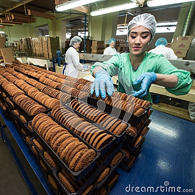 Many sweet cake food factory massive production Editorial Stock Photo