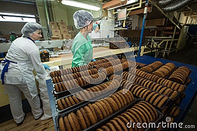 Many sweet cake food factory massive production Editorial Stock Photo