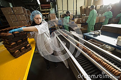 Many sweet cake food factory massive production Editorial Stock Photo