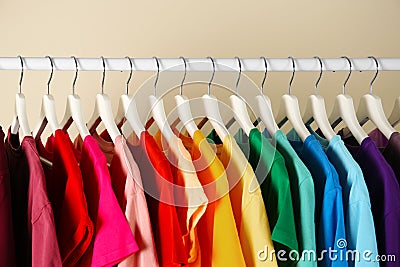 Many t-shirts hanging in order of rainbow colors Stock Photo