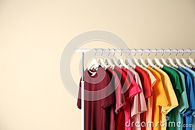 Many t-shirts hanging in order of rainbow colors Stock Photo