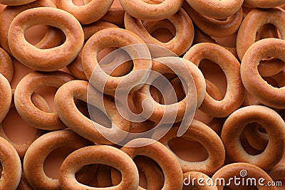 Many tasty dry bagels sushki as background, top view Stock Photo