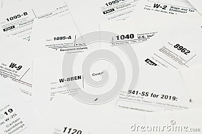 Many tax form blanks lies on table close up. Tax payers paperwork routine and bureaucracy concept Editorial Stock Photo