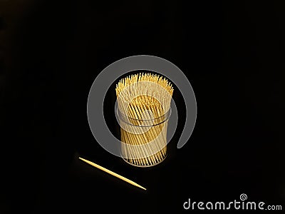 Many toothpicks are in a clear cylindrical plastic box Stock Photo