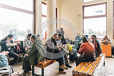 Many tourist are wearing coats eating and wait a bus for going to Taipei inside bus station in winter in Alishan, Taiwan Editorial Stock Photo