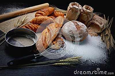many type of bread studio shot with . ingredients flour seed grain all around.photo take with high iso may has some noise and gai Stock Photo