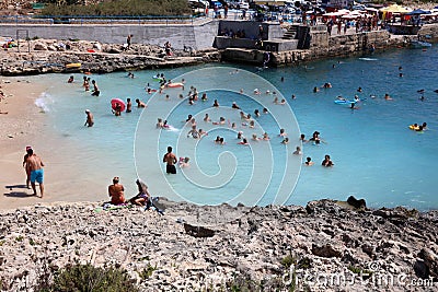 Many unidentified People on the Beach of Hondoq Bay. Island of Gozo. Malta Editorial Stock Photo
