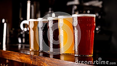 Many varieties of craft beer. Misted glass goblets with ale, lager, and unfiltered drink on bar Stock Photo