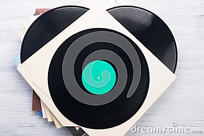 Many vinyl records in paper packaging on a gray table Stock Photo