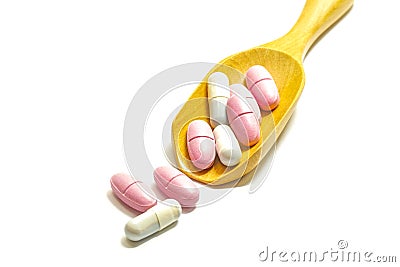 Many vitamins are in the wooden spoon on white background, Health tonic, Business selling drugs Stock Photo