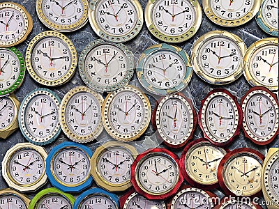 Many wall clocks on the wall Stock Photo