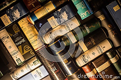 Many whisky bottle packaging arranged on a wall Editorial Stock Photo