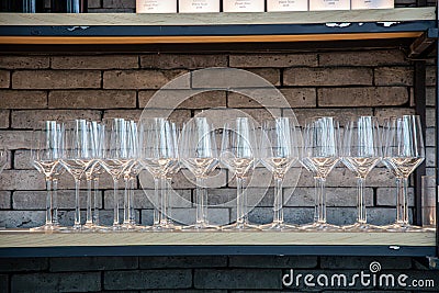 Many wine glasses arranged in a row Editorial Stock Photo