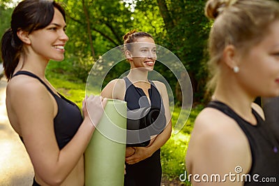 Many women with mats, group yoga training Stock Photo