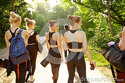Many women with mats on sidewalk, group yoga Stock Photo