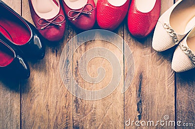 Many women`s shoes are laid on wooden floors. Stock Photo
