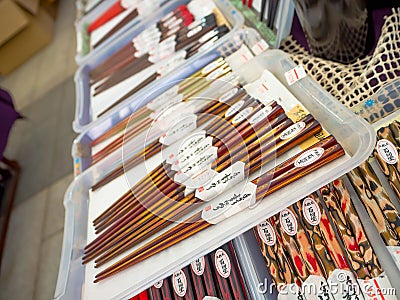 Many wooden chopsticks in a store. Decorative wooden chopsticks. Filled space with chopsticks. Chopsticks heap. Lot of Editorial Stock Photo