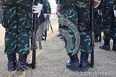 Many young soldiers stand with guns with strength. Ready to fight Natural background Stock Photo