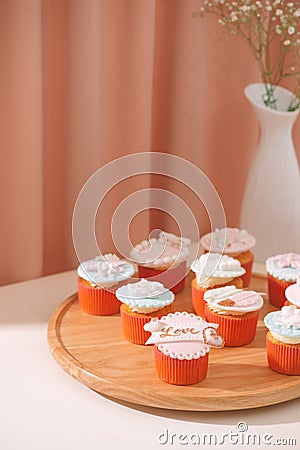 Many yummy cupcakes. Valentine sweet love cupcake on table on light background Stock Photo