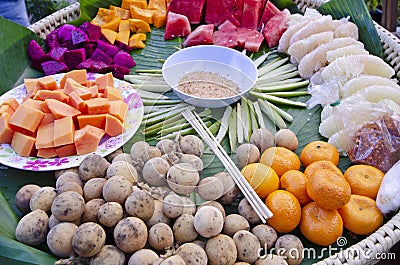 Many yummy kinds of fruits and sugar cup in a tray Stock Photo