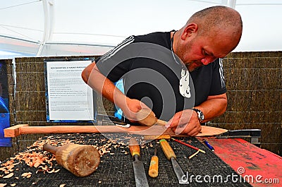 Maori man carve a Maori Wood carving Editorial Stock Photo