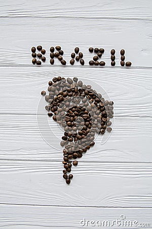 Map of the Brazil made of roasted coffee beans laying on white wooden textured background Stock Photo