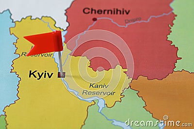 Map of Ukraine with red flag push pin placed on Kyiv, closeup Stock Photo