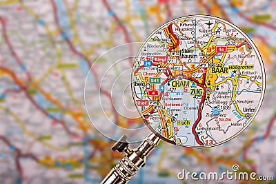 Map of Zug Baar Cham with magnifying glass on table Stock Photo