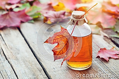 Maple syrup or healthy tincture and maple leaves. Stock Photo