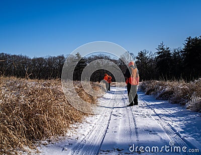 A Bird Hunter Watches His Partner In the Winter Editorial Stock Photo